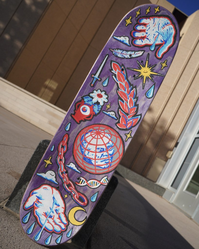 painted skateboard in a red, white, blue, and yellow color scheme depticing many things - hands, dna, feather, moon, sun